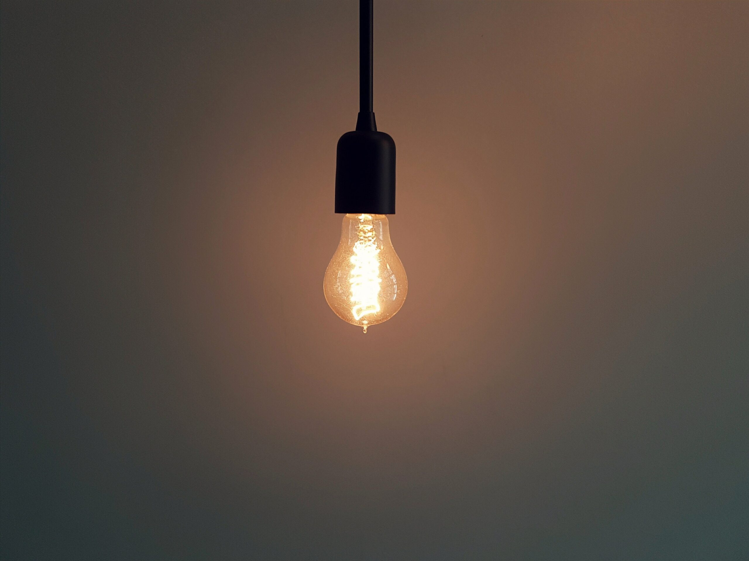 Single light bulb in dim room